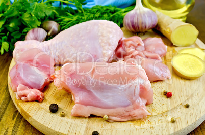chicken leg cut on a wooden board with ginger