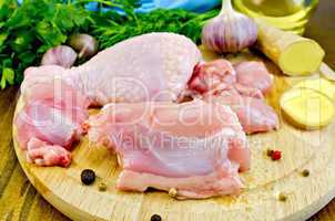 chicken leg cut on a wooden board with ginger