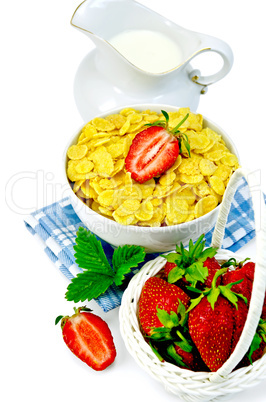 cornflakes with milk in a jug and strawberries