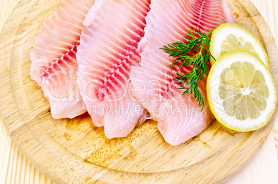 fillets tilapia on a round board