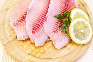 fillets tilapia on a round board