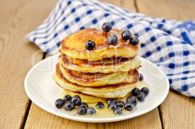 flapjacks with blueberries and a napkin on the board