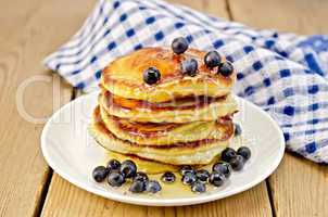 flapjacks with blueberries and a napkin on the board