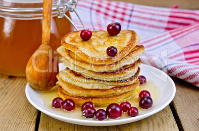 flapjacks with cranberry and spoon on board