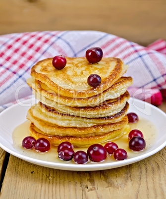flapjacks with cranberries and honey on the board