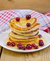 flapjacks with cranberries and honey on the board