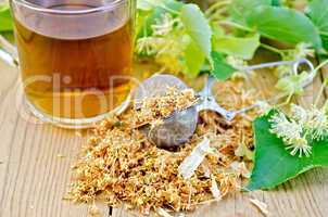 herbal tea from linden flowers in a tea strainer with mug