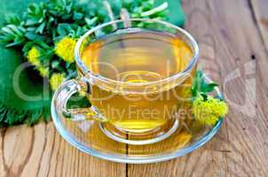 herbal tea in a cup with a bouquet of rhodiola rosea on the boar
