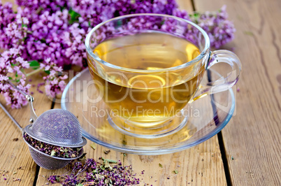 herbal tea of oregano with strainer in a glass cup