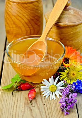 honey with flowers and briar on the board