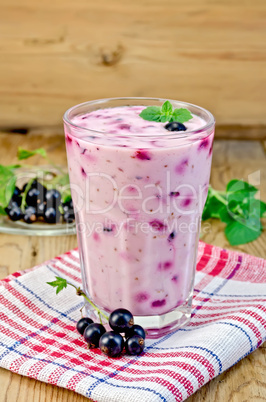 milk cocktail with black currants on the board