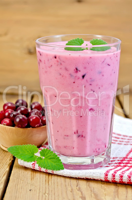 milk cocktail with cranberries on the board