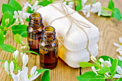 oil and white soap with flowers of honeysuckle