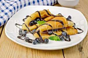pancakes with blueberries and chocolate syrup