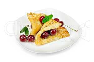 pancakes with cherries on a plate