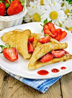 pancakes with strawberries and jam on the board