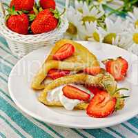 pancakes with strawberries on a napkin