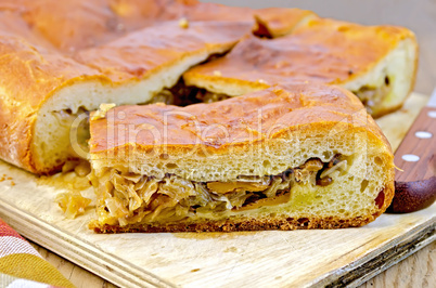 pie with cabbage and mushrooms on the board