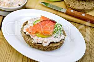 sandwich with cream and salmon on an oval plate