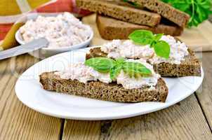 sandwiches with cream of salmon and mayonnaise on the board