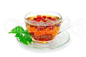 tea with raspberries and a leaf in a cup