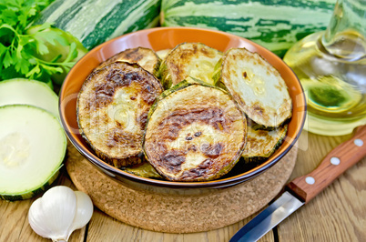 zucchini fried with garlic on a board