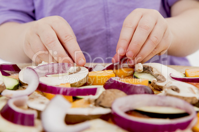 small hands preparing pizza