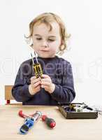 child choosing tool for repairing hard drive