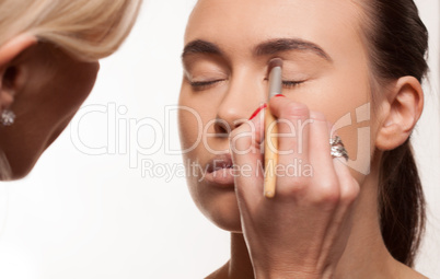 Beautician applying eye makeup