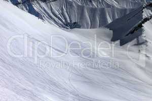 view on snowy off piste slope with trace from ski, snowboards an