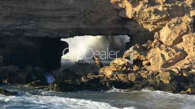 big waves braking in sandstone bridge cave 11115