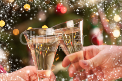 man and woman toasting champagne in front of lights