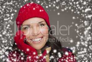smilng woman wearing winter hat and gloves with snow effect