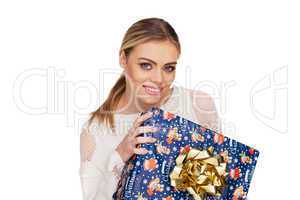 woman holds a gift wrapped in christmas paper