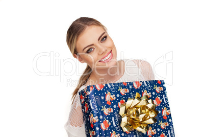 woman holds a gift wrapped in christmas paper