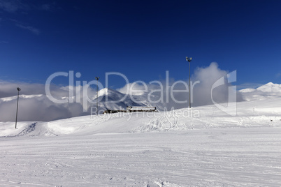ski slope and hotel in winter mountains