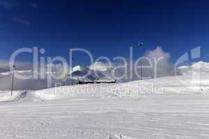 ski slope and hotel in winter mountains