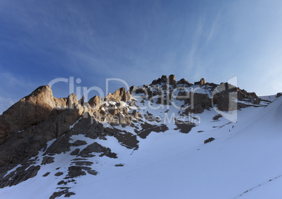 group of hikers on snowy slope in early morning
