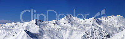 panoramic view on off-piste slopes and blue sky at nice day