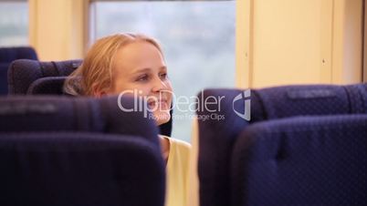 Smiling woman in the train.
