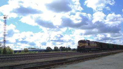 the freight train is passing by on a sunny day