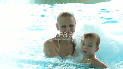 Mother and her son in the swimming pool.