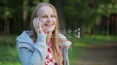 woman chatting on her mobile phone outdoors