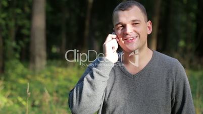 Man laughing as he chats on his mobile