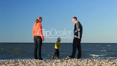 family of three on pebble beach.