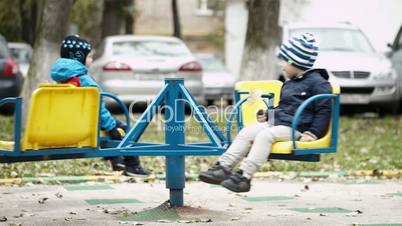 Two children on a merry-go-round