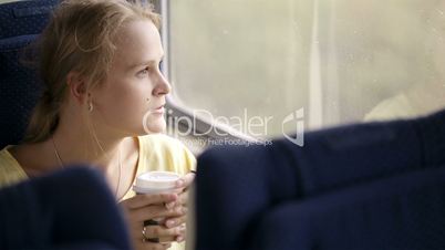 Pensive married woman traveling by train