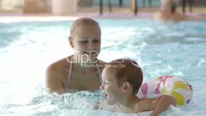 little child having swimming lessons