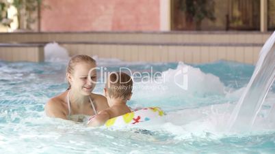 Mother and her son in the swimming pool.