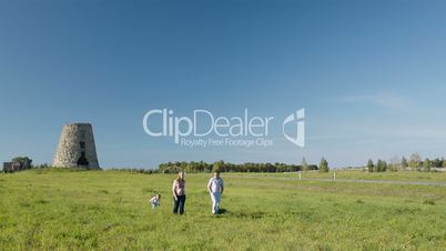 Family of three walking in the countryside.